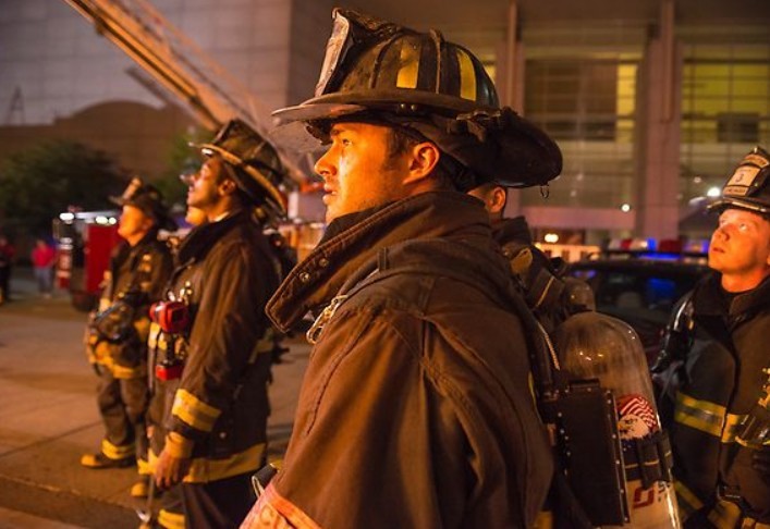 Kelly Severide (Taylor Kinney) entourer de pompiers observent le feu